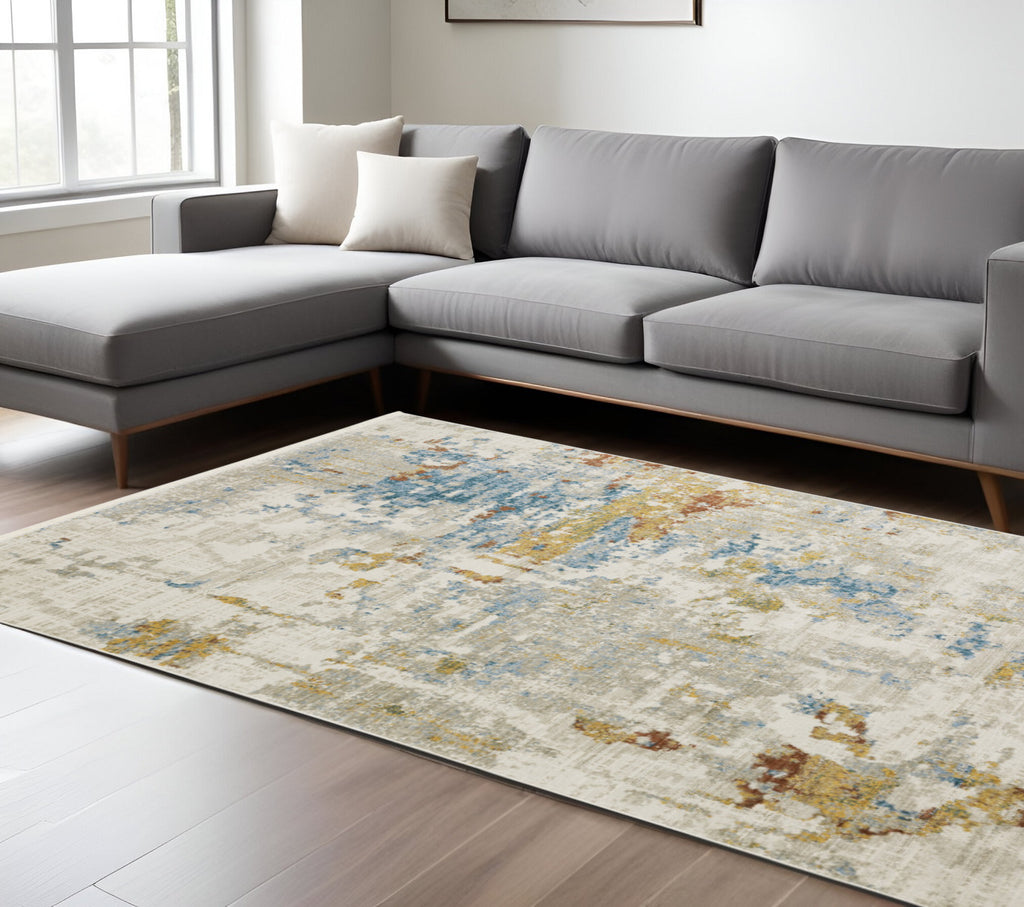 10' X 13' Beige Grey Gold Blue Rust And Teal Abstract Power Loom Stain Resistant Area Rug With Fringe